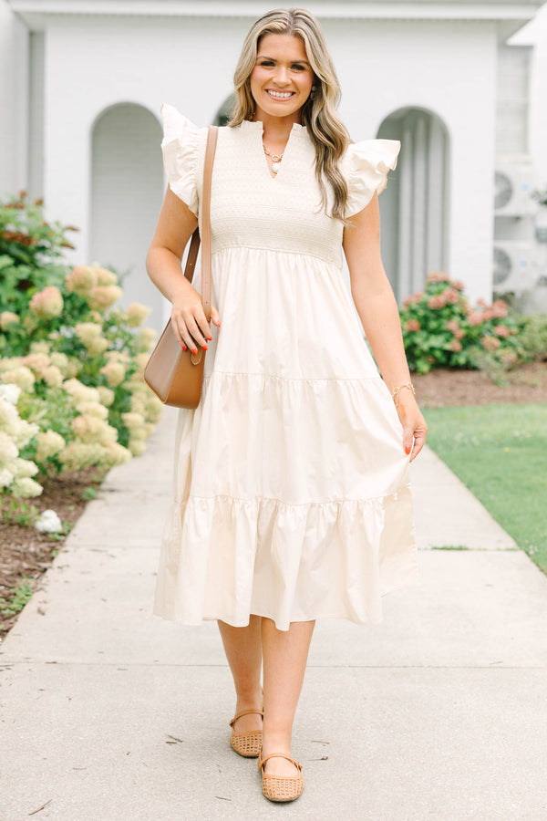 Plus size cream midi dress with ruffle sleeves, a smocked bodice, and a flowy tiered skirt.