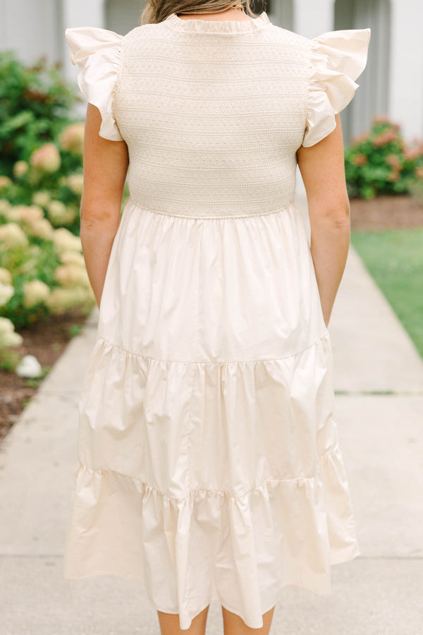 Plus size cream midi dress with ruffle sleeves, a smocked bodice, and a flowy tiered skirt.