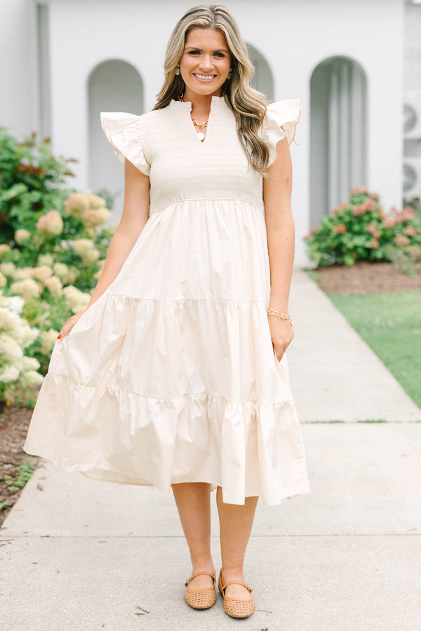 Plus size cream midi dress with ruffle sleeves, a smocked bodice, and a flowy tiered skirt.