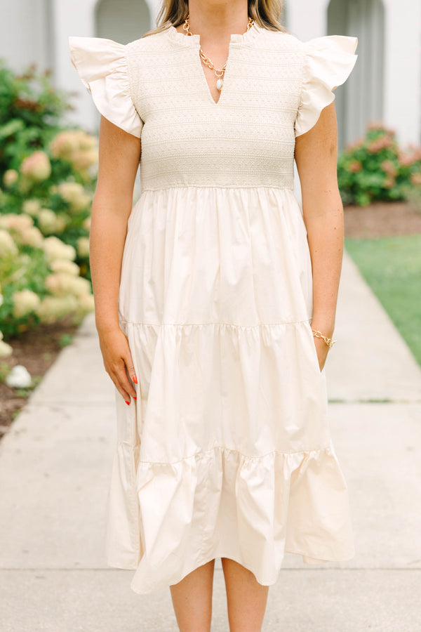 Plus size cream midi dress with ruffle sleeves, a smocked bodice, and a flowy tiered skirt.