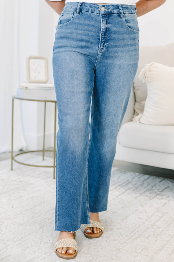 Plus Size high-rise, medium wash cropped straight-leg jeans with a raw hem.