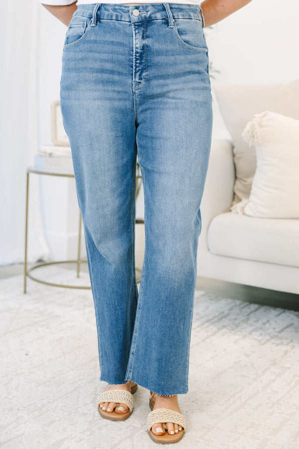 Plus Size high-rise, medium wash cropped straight-leg jeans with a raw hem.