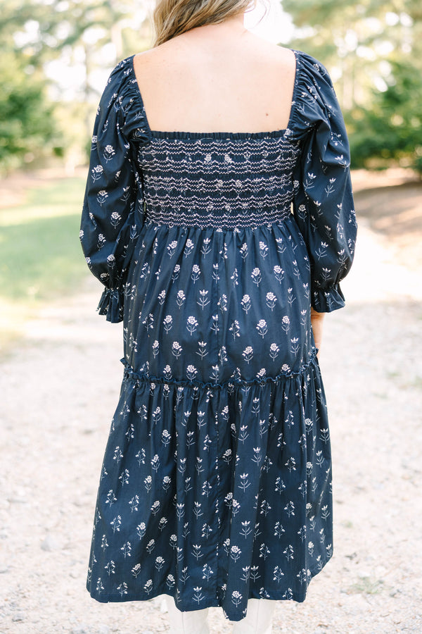 Plus Size black floral midi dress with a smocked bodice, square neckline, and long puff sleeves.