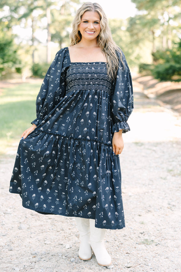 Plus Size black floral midi dress with a smocked bodice, square neckline, and long puff sleeves.