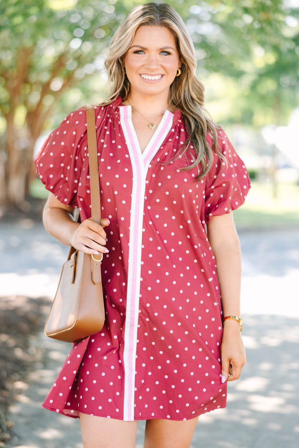 Plus size red polka-dot mini dress with a ruffled split V-neckline and flowy short sleeves.