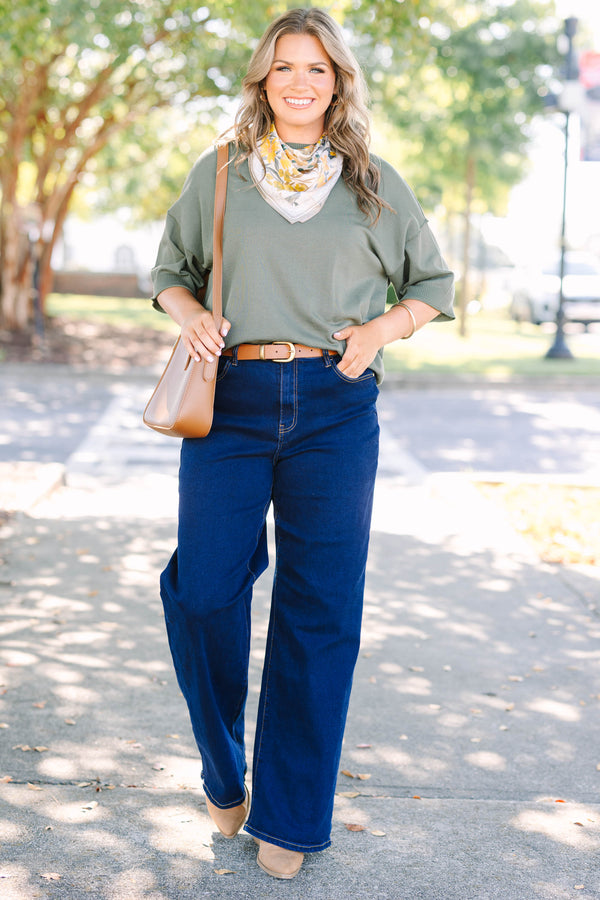 Plus size dark wash wide leg jeans with a high waist and stretchy denim fit.