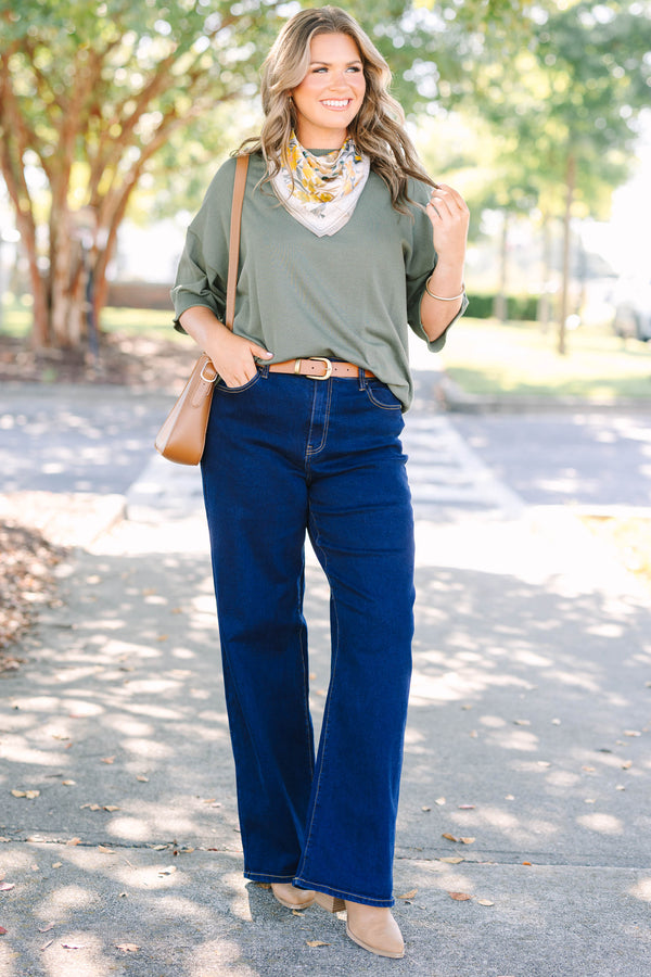 Plus size dark wash wide leg jeans with a high waist and stretchy denim fit.