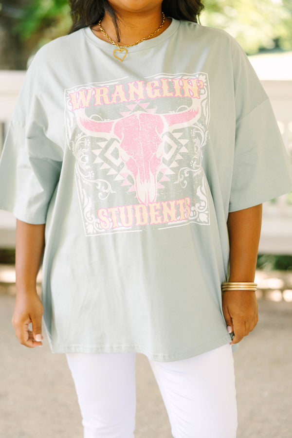 Plus size light sage boyfriend tee with a pink western bull skull graphic and flowy oversized fit.