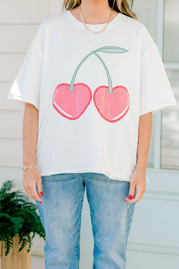 Plus Size white short sleeve top with red gingham embroidered cherry design and side slits.