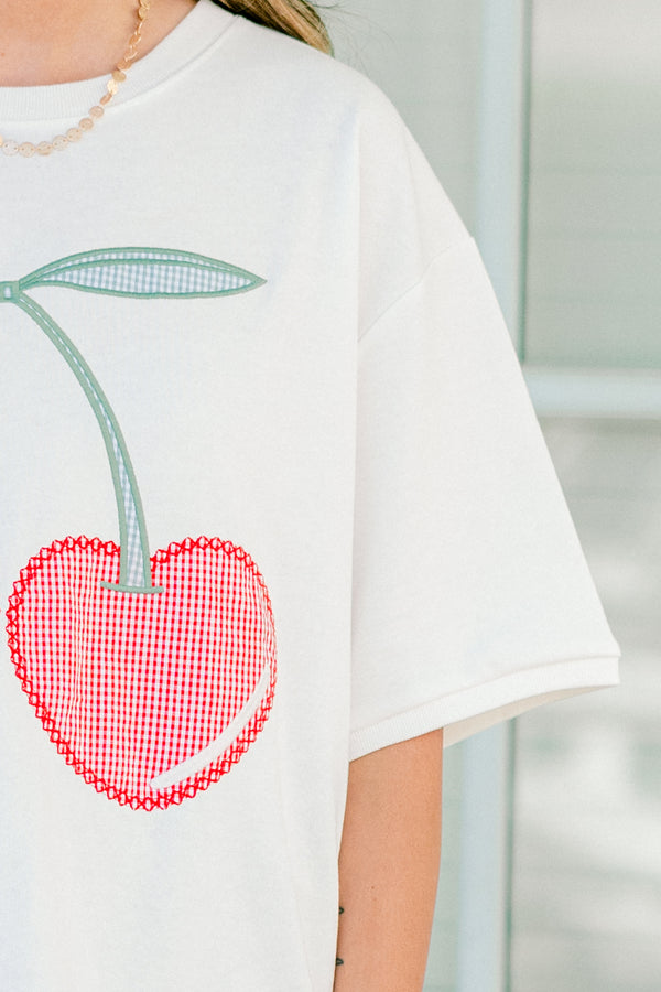 Plus Size white short sleeve top with red gingham embroidered cherry design and side slits.
