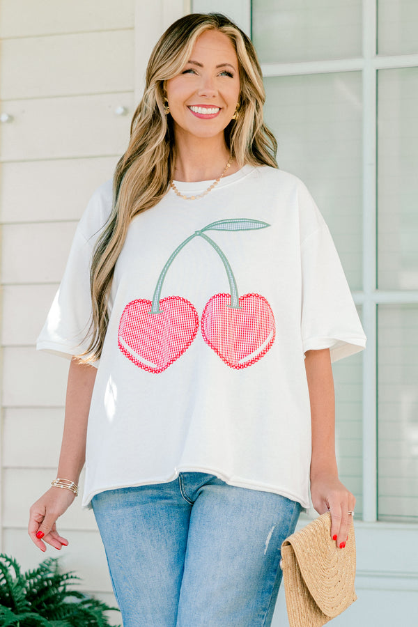 Plus Size white short sleeve top with red gingham embroidered cherry design and side slits.