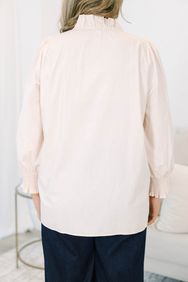 Plus size ecru cotton top with ruffle trim, smocked cuffs, and a flowy, feminine fit.