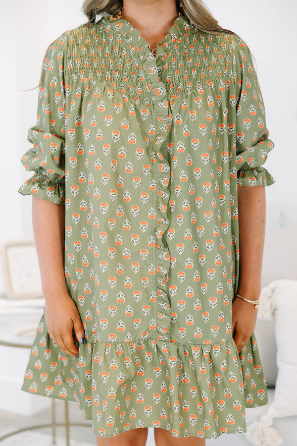 Plus size olive green floral mini dress with a flowy fit, smocked bodice, and ruffle details.