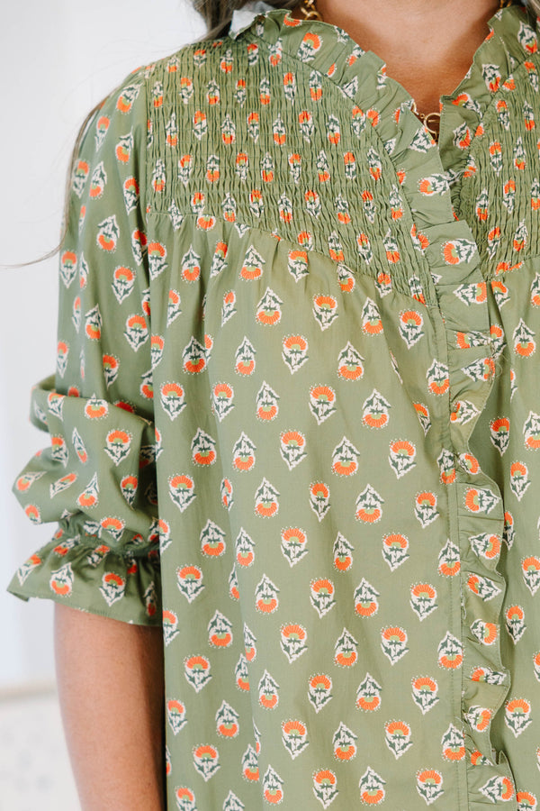 Plus size olive green floral mini dress with a flowy fit, smocked bodice, and ruffle details.