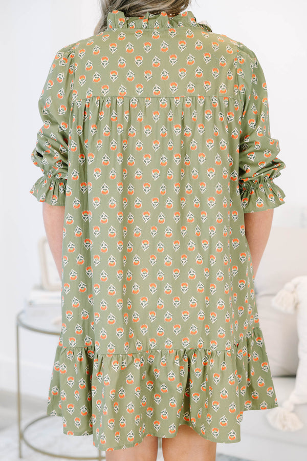 Plus size olive green floral mini dress with a flowy fit, smocked bodice, and ruffle details.