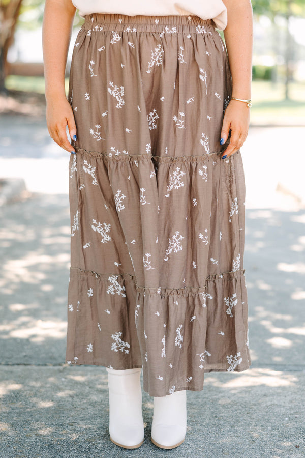Plus Size brown tiered maxi skirt with a white floral print and elastic waistband.