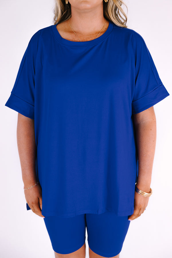 Plus Size bright blue short set with a round neck high-low top and matching biker shorts.