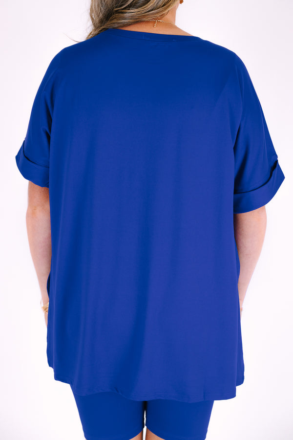 Plus Size bright blue short set with a round neck high-low top and matching biker shorts.