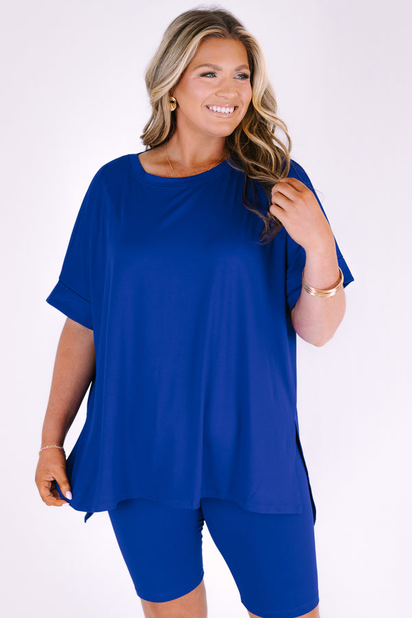 Plus Size bright blue short set with a round neck high-low top and matching biker shorts.