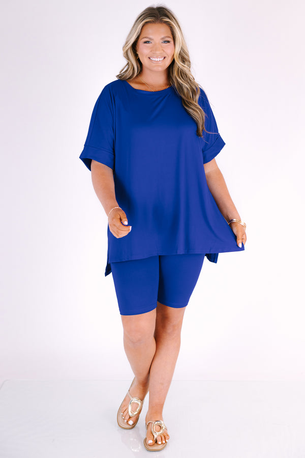 Plus Size bright blue short set with a round neck high-low top and matching biker shorts.