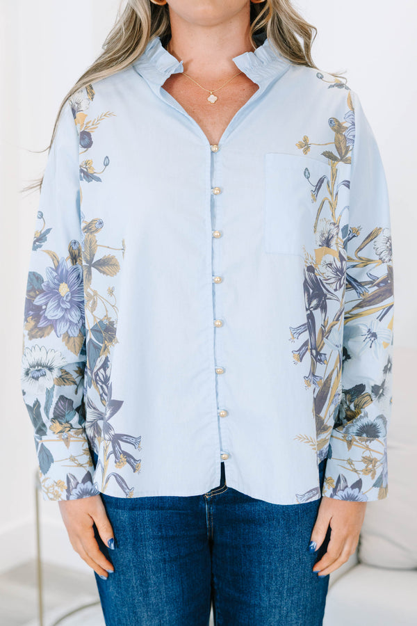 Plus Size light blue button-down cotton blouse with ruffled collar and floral prints on sleeves.