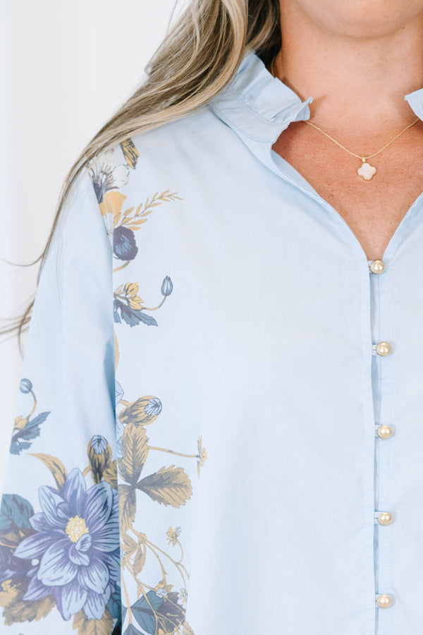 Plus Size light blue button-down cotton blouse with ruffled collar and floral prints on sleeves.