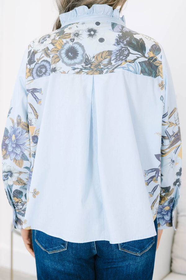 Plus Size light blue button-down cotton blouse with ruffled collar and floral prints on sleeves.