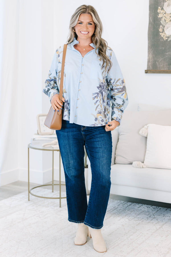 Plus Size light blue button-down cotton blouse with ruffled collar and floral prints on sleeves.