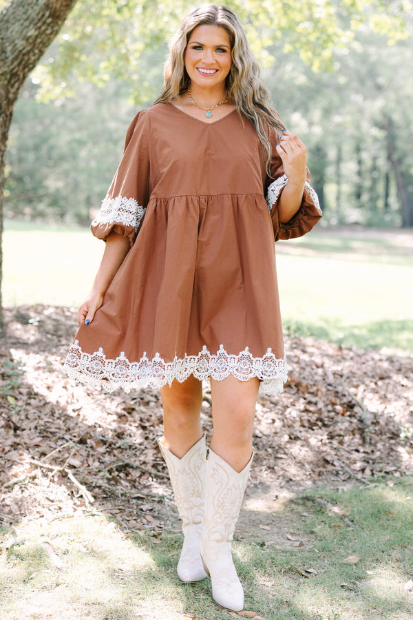 Plus size brown babydoll mini dress with puff sleeves and white crochet lace trim on hem and cuffs.