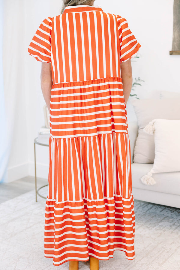 Plus size orange and white striped tiered maxi dress with puff sleeves and a flowy fit.