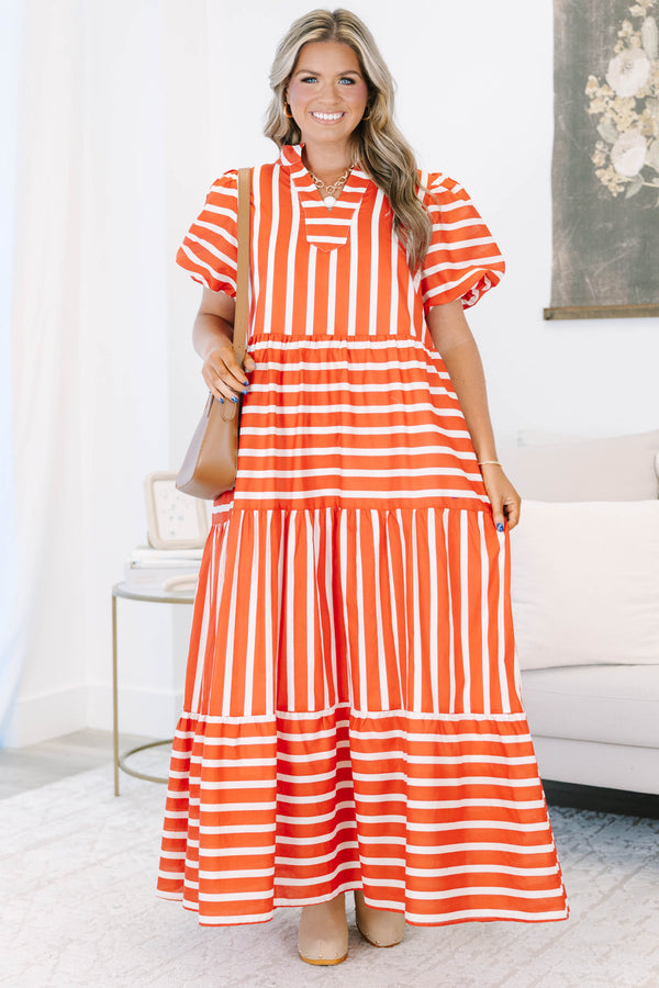 Plus size orange and white striped tiered maxi dress with puff sleeves and a flowy fit.