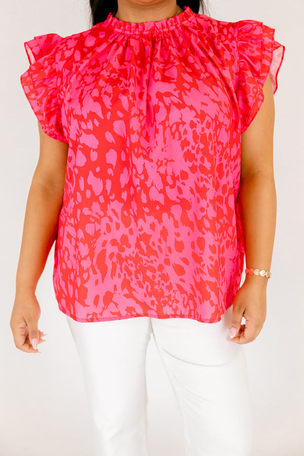 Chic Soul plus size clothing, fuchsia top with a high neck that has ruffle detailing as well as flutter sleeves and a pink abstract pattern throughout 