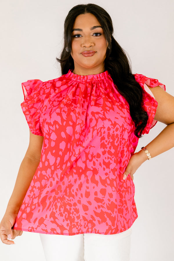 Chic Soul plus size clothing, fuchsia top with a high neck that has ruffle detailing as well as flutter sleeves and a pink abstract pattern throughout 