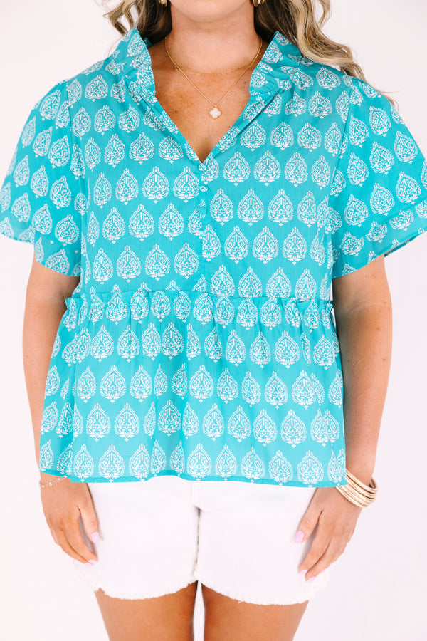 Chic Soul plus size clothing, teal top with short sleeves that have a ruffle flare on the ends of the sleeves as well as a slight v-neckline and an abstract white block pattern throughout 

