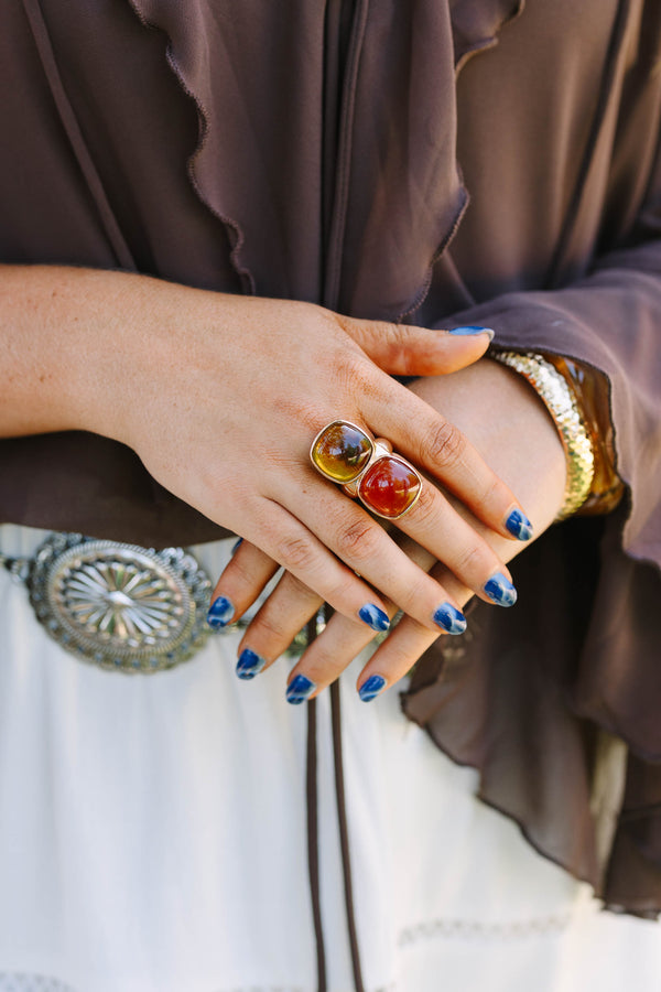 Cowgirl Charm Ring in brown and amber tones on a model with blue nails and western accessories.