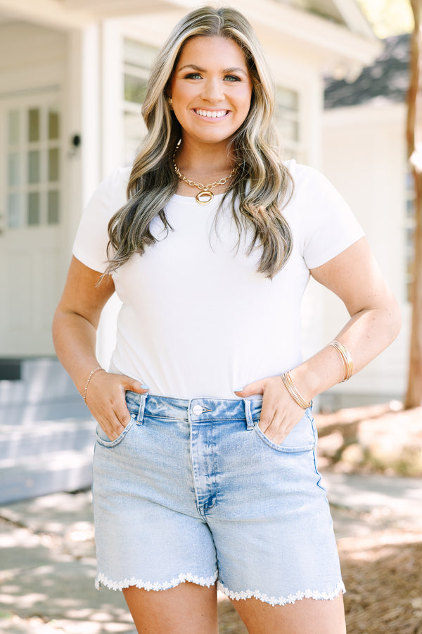 Chic Soul plus size clothing, light wash denim shorts with scalloped hemline and daisy appliques along hem