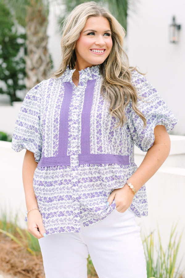 Chic Soul plus size clothing, purple top with short bubble sleeves and a floral leafy pattern throughout the top as well as purple  textured fabric going down the both sides of the chest and under the bust area 