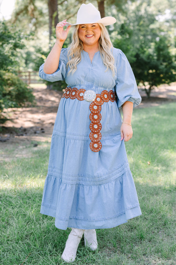 Plus Size blue denim tiered maxi dress with puff sleeves, a v-neckline, and a brown concho belt.