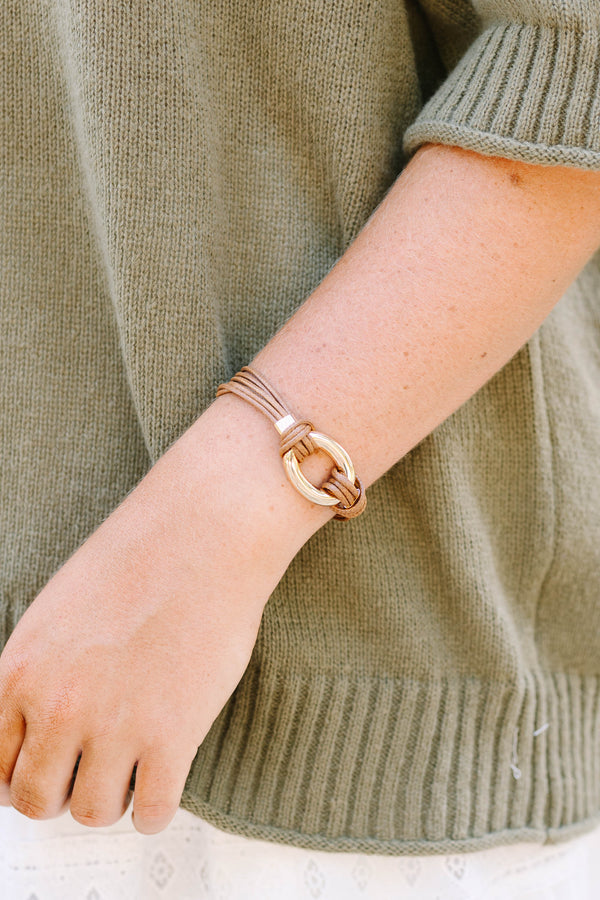 Desert Darling Bracelet in brown featuring multi-strand cord and a gold oval ring clasp.