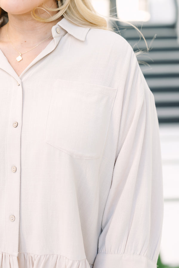 Chic Soul plus size clothing, tan long sleeve top with collar and buttons down the front and a ruffle babydoll style hem at the bottom of the top