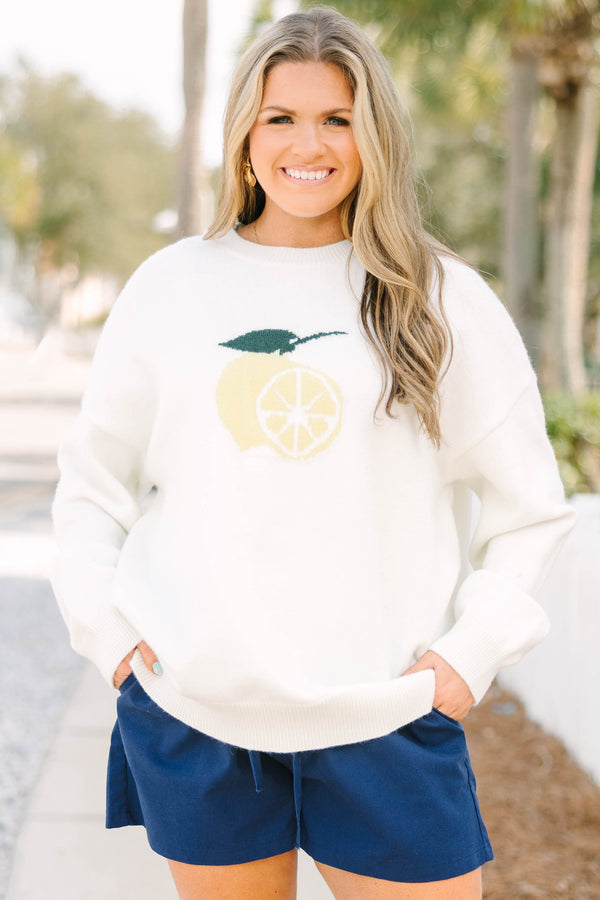 Chic Soul plus size clothing, ivory long sleeve knit sweater with light yellow lemon cut in half with one side showing the inside of the lemon and the other showing the outside with a green leaf and stem