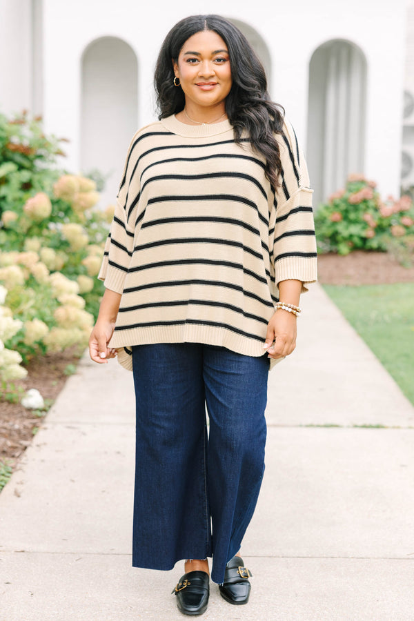 taupe sweater with drop shoulders and black stripes with exposed seam details