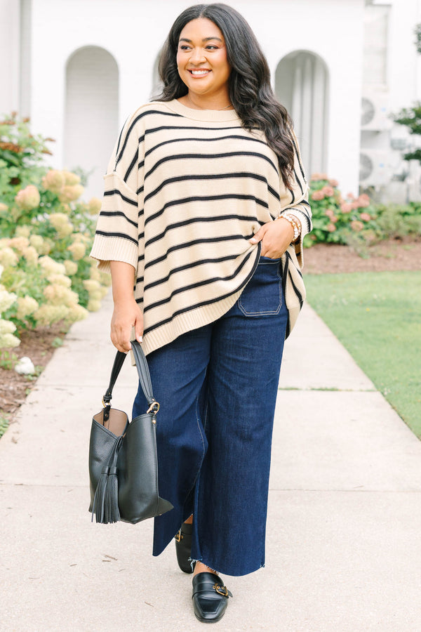 taupe sweater with drop shoulders and black stripes with exposed seam details