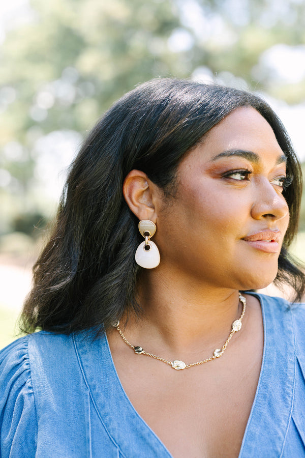 Plus Size gold drop earrings with two-tier neutral stone pendants and a gold chain necklace.