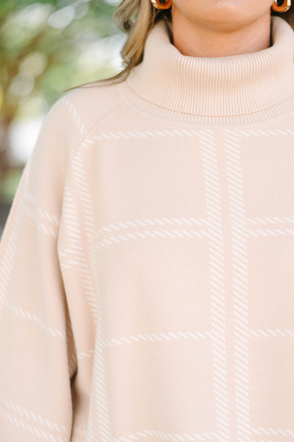 Plus Size taupe turtleneck sweater with a white windowpane plaid pattern and wide bell sleeves.