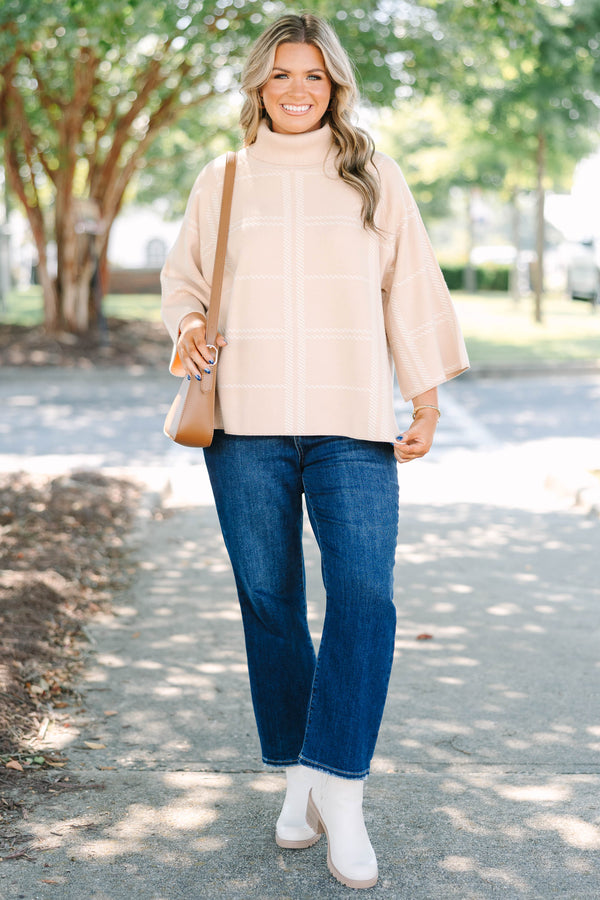Plus Size taupe turtleneck sweater with a white windowpane plaid pattern and wide bell sleeves.