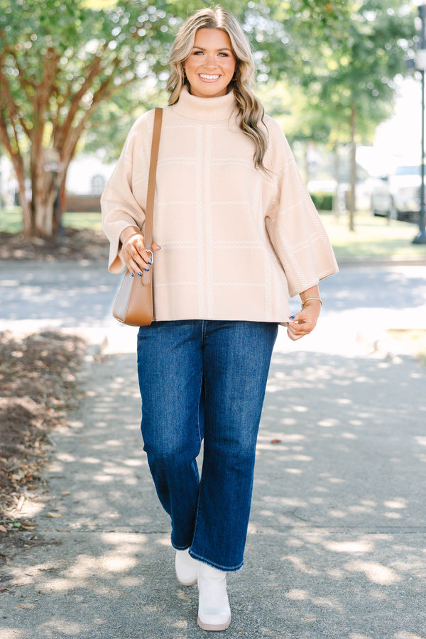 Plus Size taupe turtleneck sweater with a white windowpane plaid pattern and wide bell sleeves.