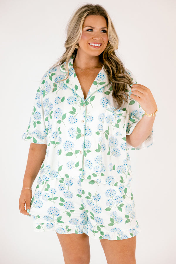 Plus Size short-sleeve pajama set with blue hydrangea print, ruffle trim, and button-down front.