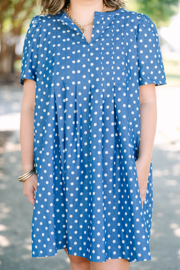 Plus Size navy blue short sleeve dress with white polka dots and a split v-neckline.