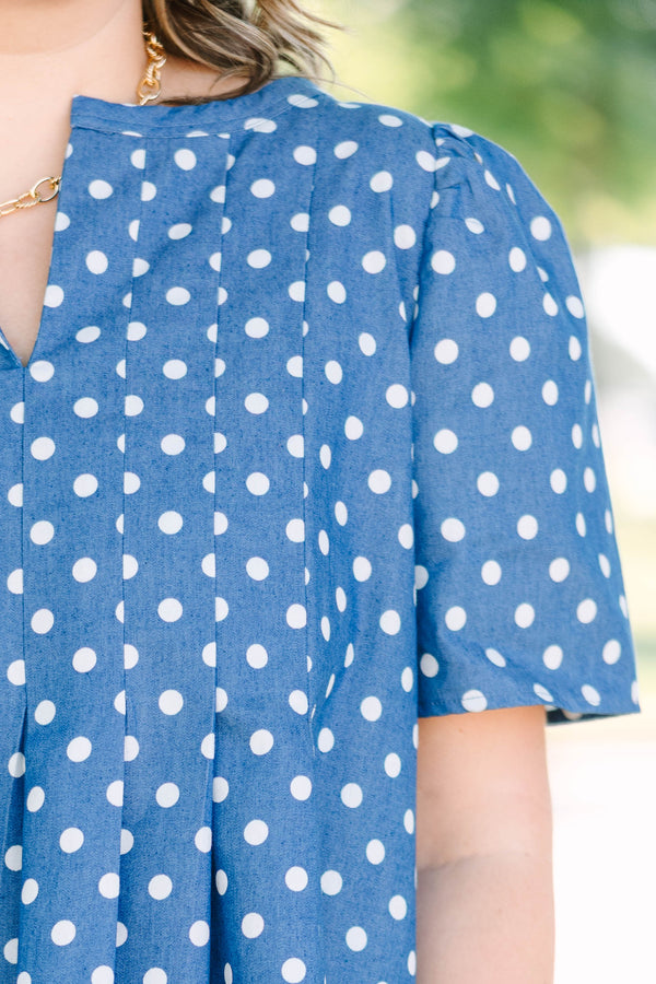 Plus Size navy blue short sleeve dress with white polka dots and a split v-neckline.